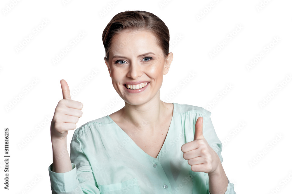 Obraz premium Happy young woman shows thumbs up isolated on white background