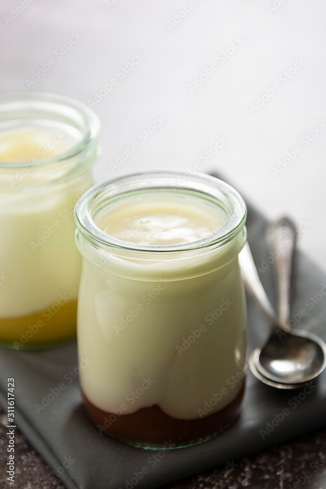 Fresh yogurt in glass jar with fruit jam. Healthy food, milk diary. Fresh yogurt in glass jar with fruit jam. Healthy food, milk diary.