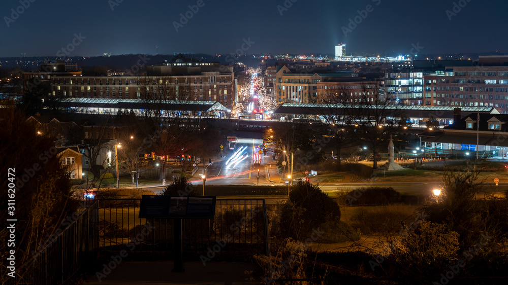 Looking down King Street and Old Town Alexandria, Virginia at night time during the Christmas season.