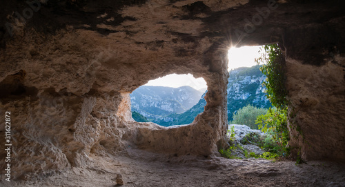 Inside view of a rock-cut tomb in the necropolis of Pantalica in southeast Sicily photo