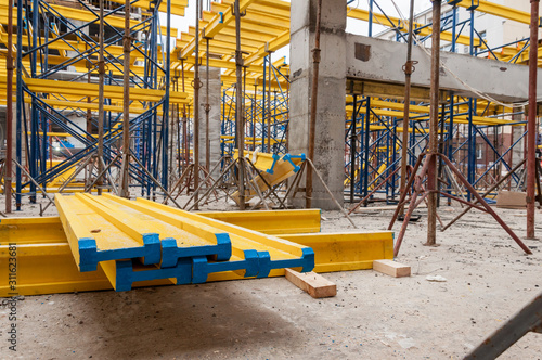 Yellow wooden beams for monolithic building construction