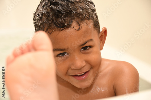 Toddler sticks his foot up at bathtime 