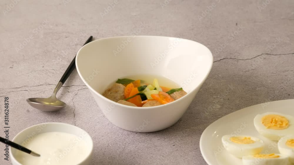 Vegetable soup with meatballs was poured into a bowl. Cooking vegetable soup. Vegetable soup with meatballs was poured into a bowl. Cooking vegetable soup.