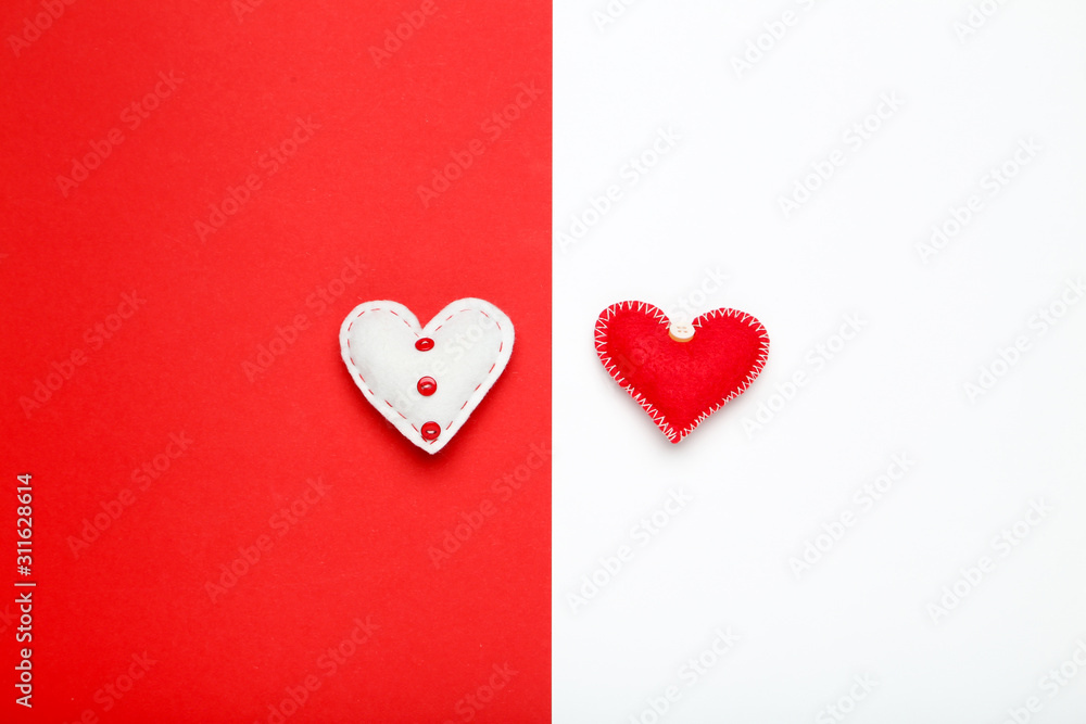 Fabric hearts on colorful paper background Fabric hearts on colorful paper background