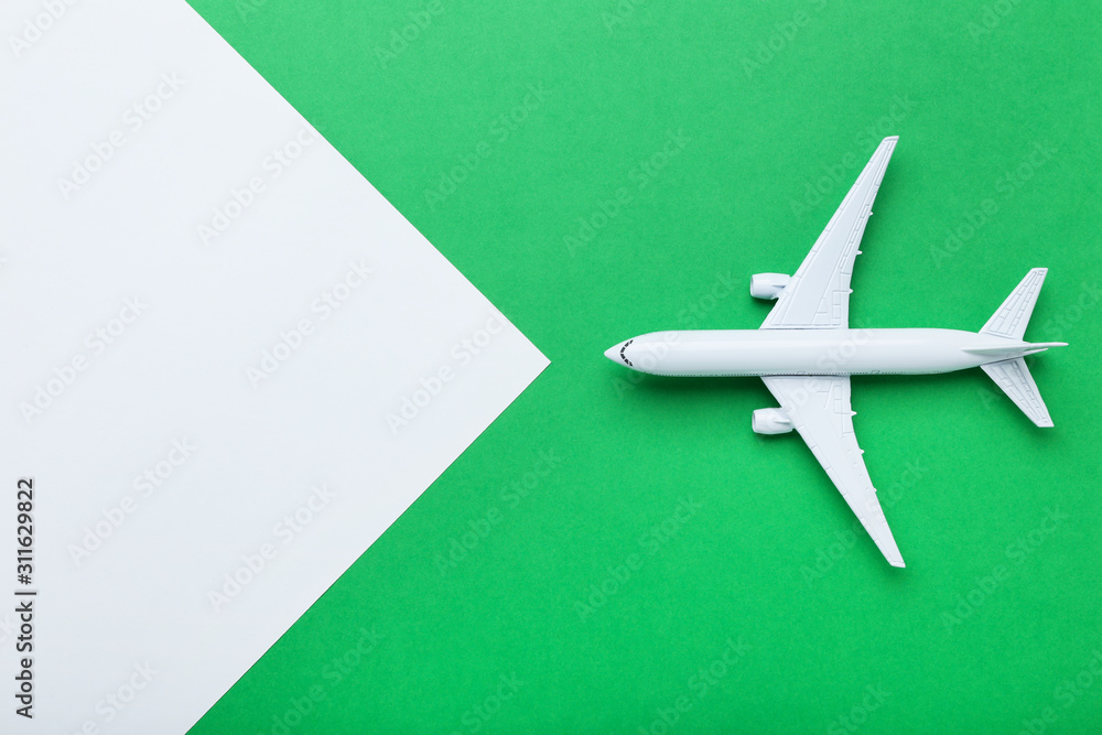 Airplane model on green paper background Airplane model on green paper background