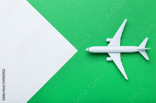 Airplane model on green paper background