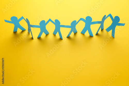 Paper chain people on yellow background