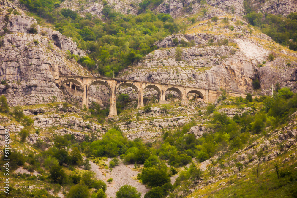 The view of old high mountain breathtaking railway viaduct or mountain bridge of old railway in MONTENEGRO, Europe