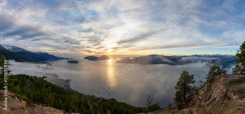 Fototapeta Naklejka Na Ścianę i Meble -  Tunnel Bluffs Hike, in Howe Sound, North of Vancouver, British Columbia, Canada. Panoramic Canadian Mountain Landscape View from the Peak during sunny winter sunset.