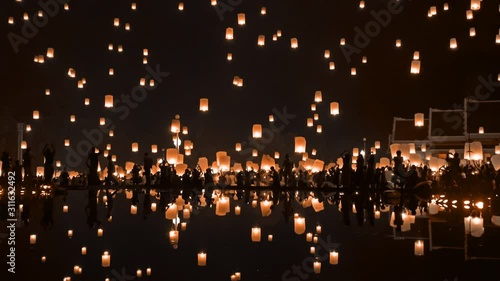Thai people release sky floating lanterns or lamp to worship Buddha's relics at night. Traditional festival in Chiang mai, Thailand. Loy krathong and Yi Peng Lanna ceremony. Celebration background.