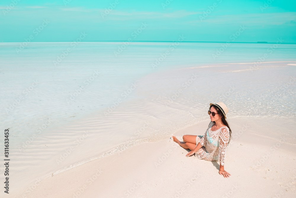 Woman laying on the beach enjoying summer holidays looking at the sea Woman laying on the beach enjoying summer holidays looking at the sea