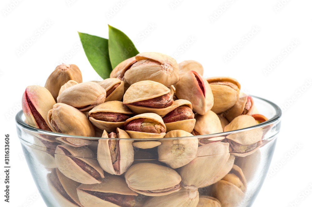 Fototapeta premium Pistachios in Glass Bowl on white background