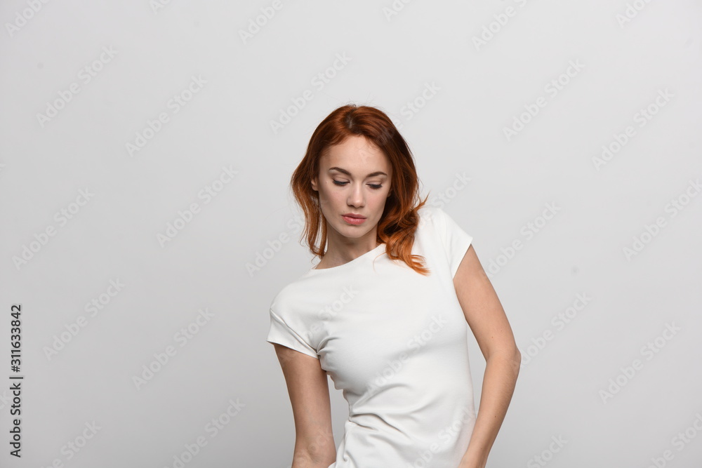 portrait of young woman, isolated on white. Red hair, beautiful eyes and lips, model appearance, waist-length shot in light beidge-white dress with short sleeves portrait of young woman, isolated on white. Red hair, beautiful eyes and lips, model appearance, waist-length shot in light beidge-white dress with short sleeves