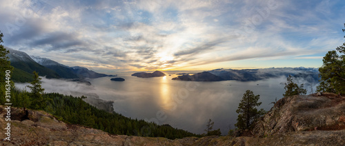 Tunnel Bluffs Hike, in Howe Sound, North of Vancouver, British Columbia, Canada. Panoramic Canadian Mountain Landscape View from the Peak during sunny winter sunset.
