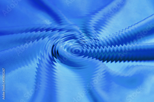 Bright blue satin or silk fabric with large swirl folds, graphic pattern. The material is flexible and light in design, can be used as wallpapers and backgrounds. Abstract background, selective focus.