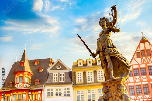 Old town square Romerberg with Justitia statue in Frankfurt Main, Germany with blue sky photo