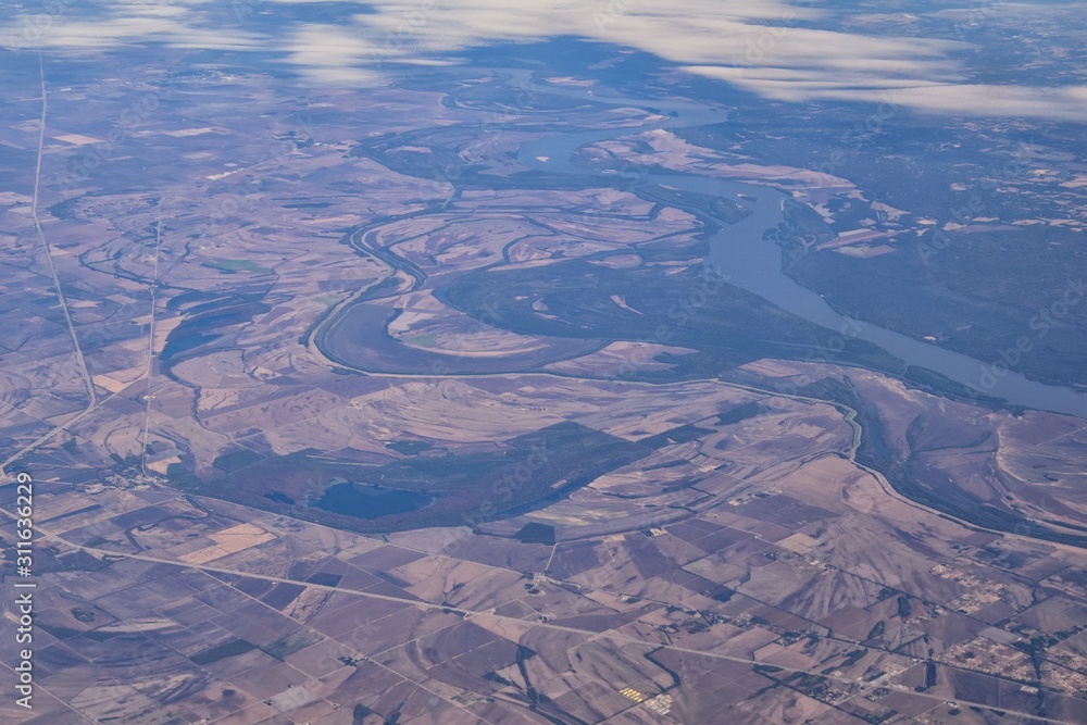 Mississippi River aerial landscape views from airplane over the border of Arkansas and Mississippi. Winding river and Rural town and cities, United States of America. USA.
