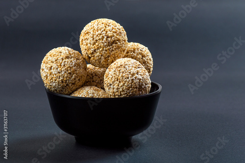 Canvastavla Amaranth or Rajgira laddu, Cholai ke laddo in black Bowl on black background