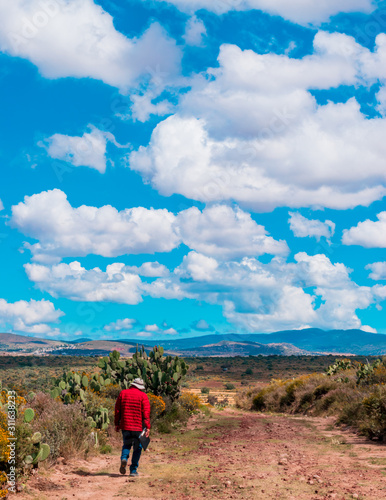 Man walking in an arid landscape © Jessica