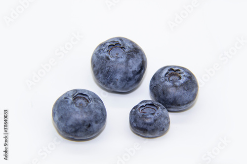 Fresh blueberry on white background. A composition of the four blueberries which is organic and healthy. The berry full of vitamins.