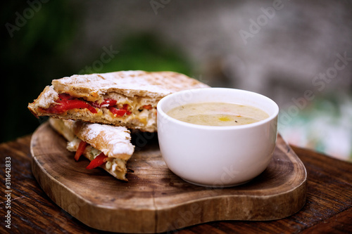 Delicious soup accompanied with sandwich