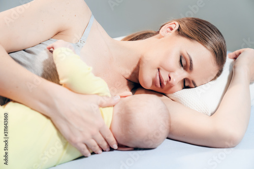 mother breastfeeding baby at home