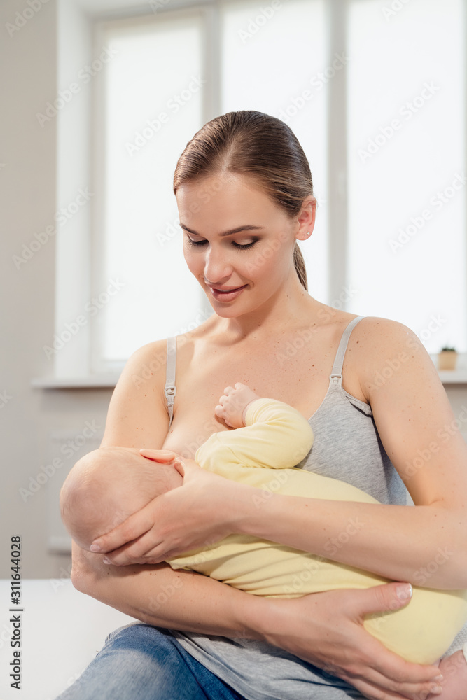 mother breastfeeding baby at home. Breastfeeding mother with little child mother breastfeeding baby at home. Breastfeeding mother with little child