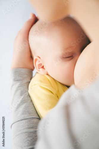 mother breastfeeding baby at home