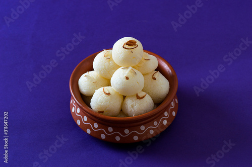 ndian Sweet or Dessert - Rasgulla in clay pot photo