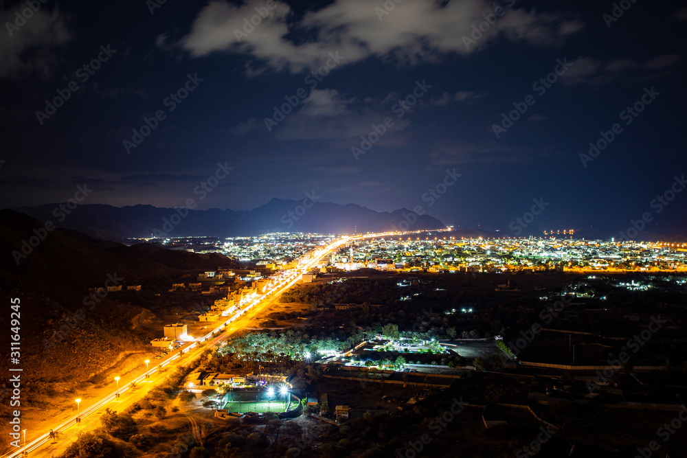 view from the mountain to the night city on the ocean