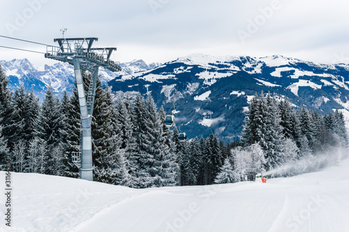 Mountains ski resort Zell am See Kaprun, Austria with snowy forest, cable car and snow in Austrian Alps © Julia Lavrinenko