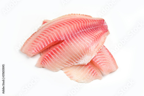 Leinwand Poster Raw tilapia fillet fish isolated on white background for cooking food - Fresh fi