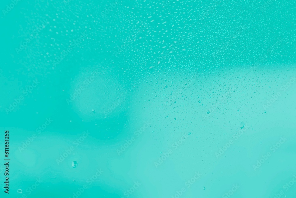 Raindrops on window glass. Mint aquamarine color gradient abstract background Raindrops on window glass. Mint aquamarine color gradient abstract background