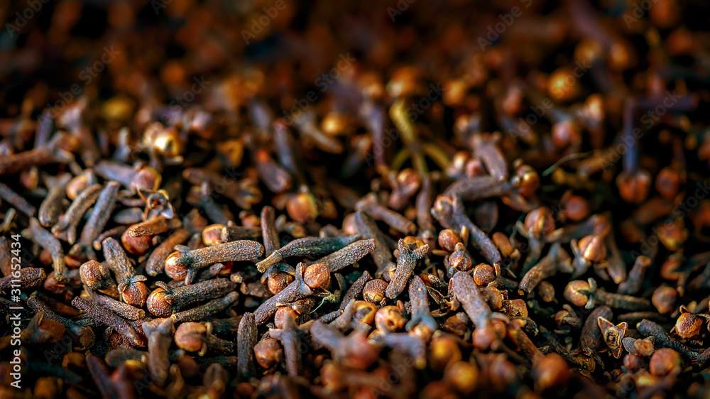 close up clove dried spicy herb for cooking and natural medicine. macro photography texture background
