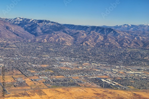 Wasatch Front Rocky Mountain Range Aerial view from airplane in fall including urban cities and the Great Salt Lake around Salt Lake City, Utah, United States of America. USA.