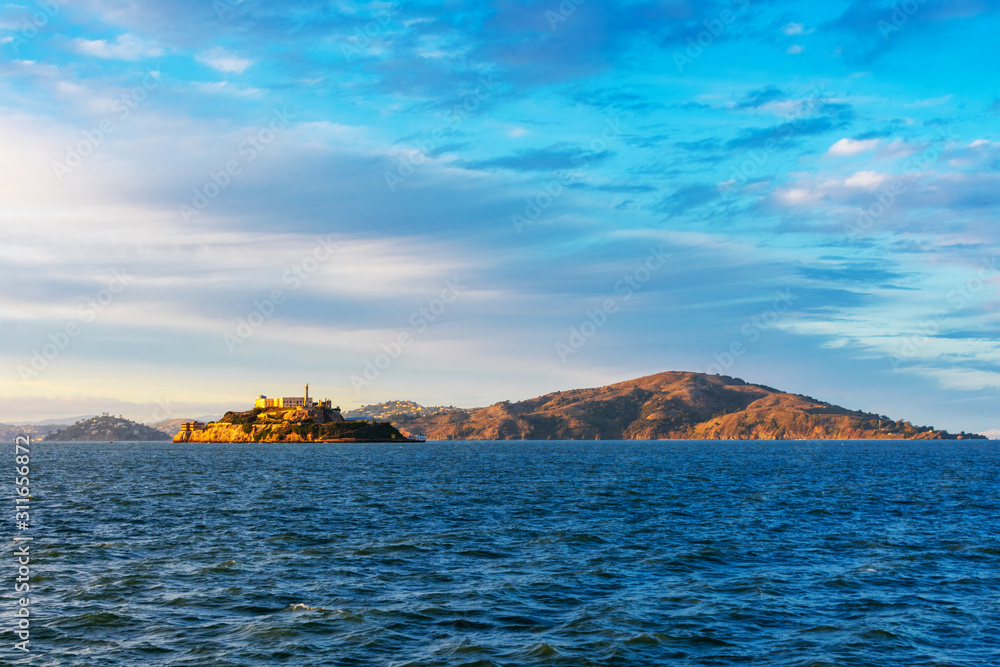 Sunset view of scenic San Francisco Bay coastline from the pier in San Francisco in the direction of Tiburon, Alcatraz and Angel islands