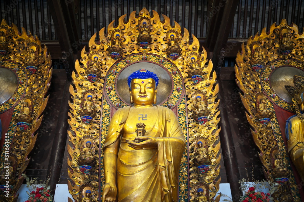 Shanghai,China-September 16, 2019: Buddha statue at Longhua temple in Shanghai, China Shanghai,China-September 16, 2019: Buddha statue at Longhua temple in Shanghai, China