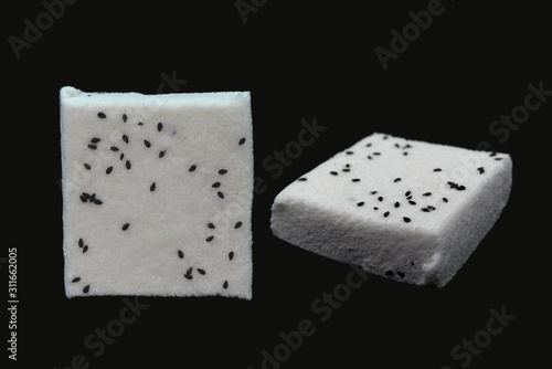 Chinese snack with black background. Dessert is white and auspicious snack. Kind of Chinese pancake made of rice-flour. photo