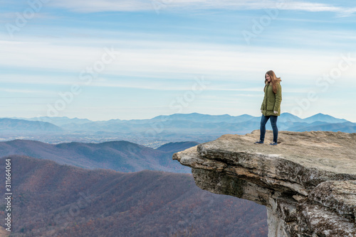 Young woman on the observation point on McAfee Knob