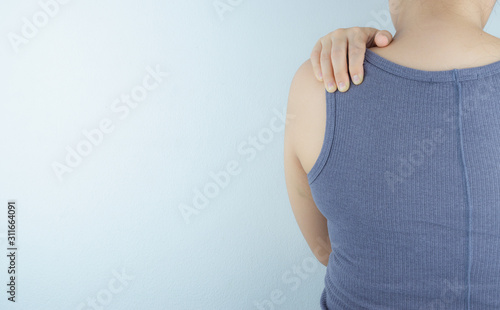 Closeup woman suffering from neck and shoulder pain. Health care and medical concept.