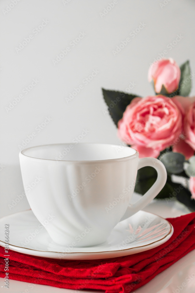 White cup for coffee on a red napkin White cup for coffee on a red napkin