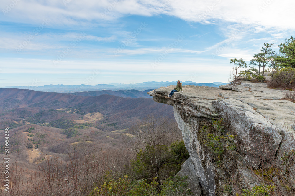 Fototapeta premium Young woman on the observation point on McAfee Knob