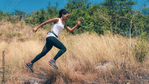 african american woman having exerice with trail running at natural mountain © Mongkolchon