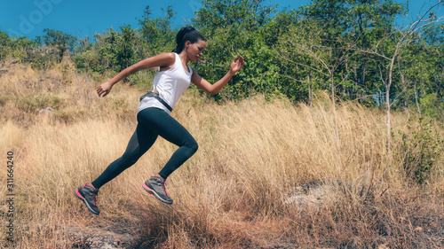 african american woman having exerice with trail running at natural mountain photo