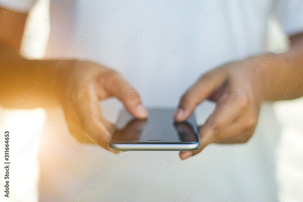 Front view, Woman hands using mobile smartphone on sunset background. Front view, Woman hands using mobile smartphone on sunset background.