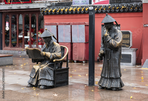 Sculpture of two examiners with official robes of Qing Dynasty in front of historical Jiangnan Examination Hall on Gongyuan Street at Confucius Temple or Fuzimiao, Qinhuai, Nanjing, Jiangsu, China