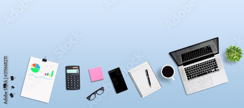 Top view office desk and supplies, with copy space. Creative flat lay photo of workspace desk - panoramic blue background