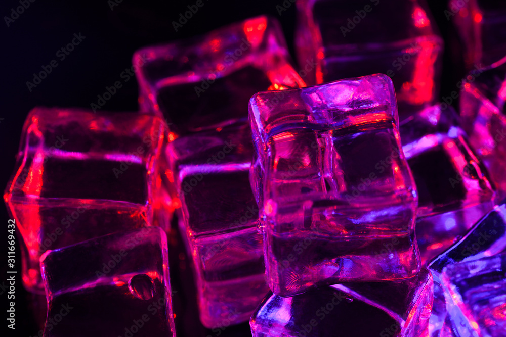 Ice cube. Close-up of melting ice cubes with red and purple illumination on a black background. Macro horizontal photography Ice cube. Close-up of melting ice cubes with red and purple illumination on a black background. Macro horizontal photography