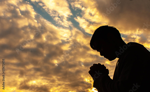 silhouette of man that praying for god and sunset