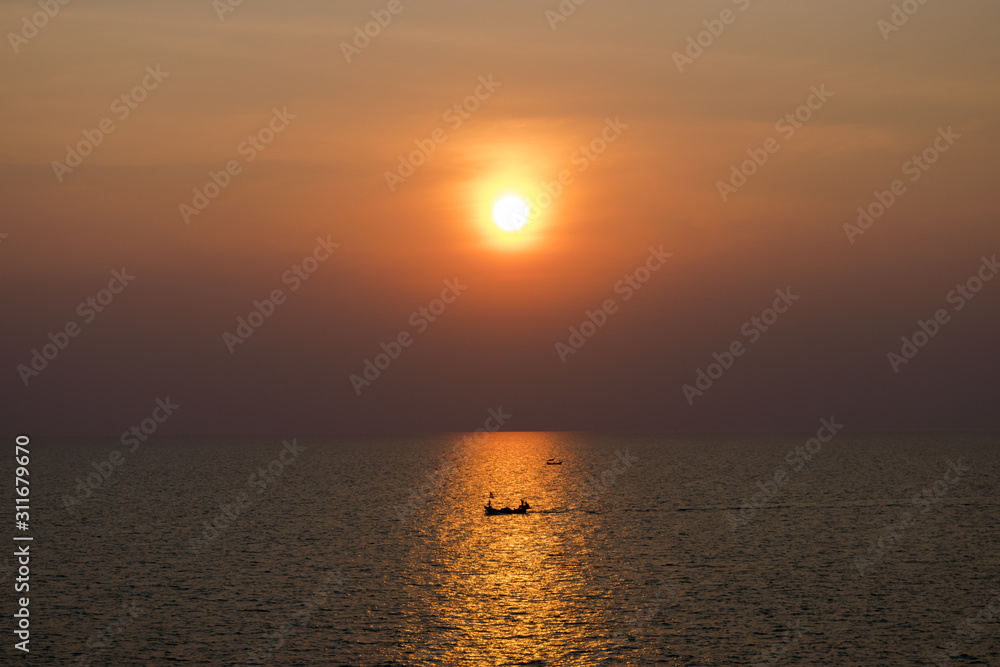 the sun falls Thai sea and fishing tiny boat ,